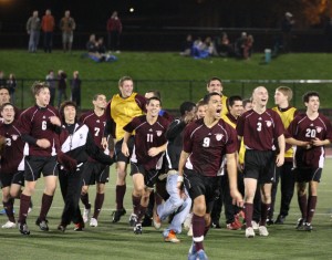 Celestin (center) celebrates his game-winning goal in front of the Garnet bench.