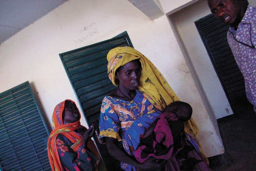 A woman holding a sick child